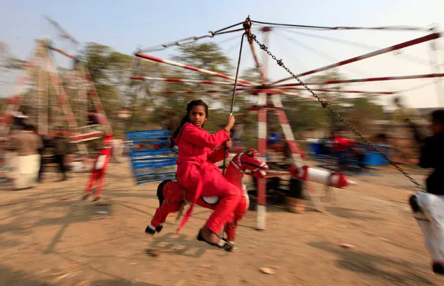 A girl rides on a makeshift merry go round on Christmas Day in Islamabad, Pakistan, December 25, 2016. (Photo by Faisal Mahmood/Reuters)