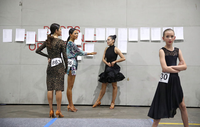 Competitors warm up and look at the cometition lists back stage during the 73rd Australian DanceSport Championship at Melbourne Arena on December 7, 2018 in Melbourne, Australia. Over 1000 competitive ballroom athletes aged between 10 and 65 years are taking part in the competition, with major events deciding Australia's representatives for all 2019 World Championships. (Photo by Scott Barbour/Getty Images)