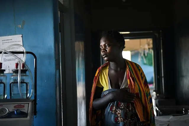 A woman in labour, walks to her delivery bed at Malawi Government's Mauwa Health Centre labour ward in Chiradzulu, southern Malawi, Sunday, May 23, 2021. Health officials in Malawi say fewer women are getting prenatal care amid the COVID-19 pandemic. At risk are the developing country's gains on its poor rate of maternal deaths. (Photo by Thoko Chikondi/AP Photo)