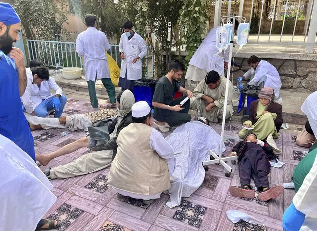 In this handout photo released by MSF Afghanistan, injured people received treatment after a powerful earthquake in Herat province, western of Afghanistan, Sunday, October 15, 2023. (Photo by MSF Afghanistan via AP Photo)