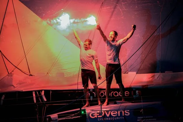 French skipper of the “For People” Thomas Ruyant (L) celebrates with his co-skipper Morgan Lagraviere (R) while crossing the finish line to win the Transat Jacques Vabre Imoca category sailing race, from Le Havre to the French overseas island of Martinique, in Fort-de-France, Martinique on November 19, 2023. (Photo by Loic Venance/AFP Photo)