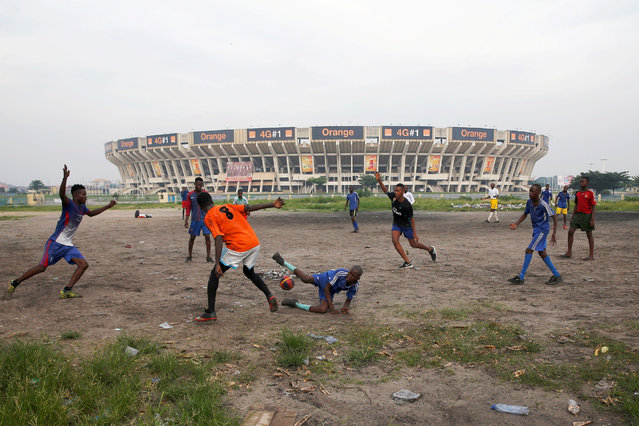 Youth play soccer in front of the Stade Des Martyrs stadium in Kinshasa, Democratic Republic of Congo on January 3, 2019. (Photo by Baz Ratner/Reuters)