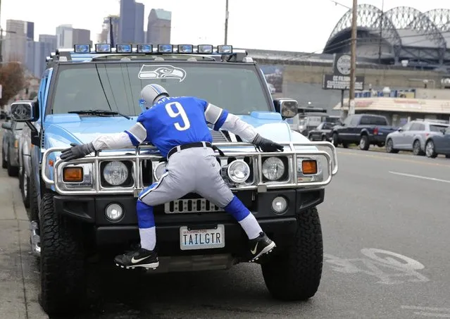 A Seattle Seahawks fan vehicle sits parked with an effigy of Detroit Lions quarterback Matthew Stafford on the hood and bumper near CenturyLink Field before an NFL football NFC wild card playoff football game between the Seahawks and the Lions, Saturday, January 7, 2017, in Seattle. (Photo by Stephen Brashear/AP Photo)