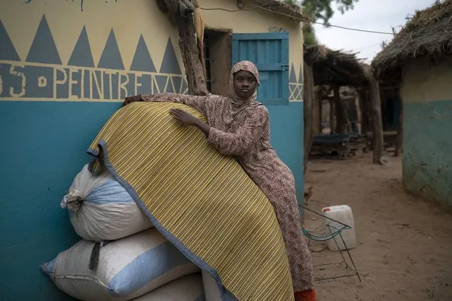 In this November 26, 2018 photo, Mariama Konte, 20, stands near her home in a village near Goudiry, Senegal. Konte, who married Abdrahamane when she was 12 and he was 21, is living the consequences of the family's decision in November to mourn him after nearly four years of waiting. Friends and neighbors told them they would feel better if they went ahead with the ceremony, as five other families from the same shipwreck already had. (Photo by Felipe Dana/AP Photo)
