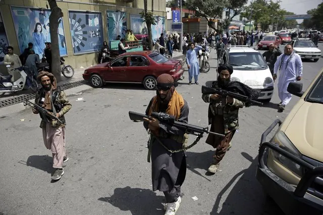 Taliban fighters patrol in Kabul, Afghanistan, Thursday, August 19, 2021. The Taliban celebrated Afghanistan's Independence Day on Thursday by declaring they beat the United States, but challenges to their rule ranging from running a country severely short on cash and bureaucrats to potentially facing an armed opposition began to emerge. (Photo by Rahmat Gul/AP Photo)