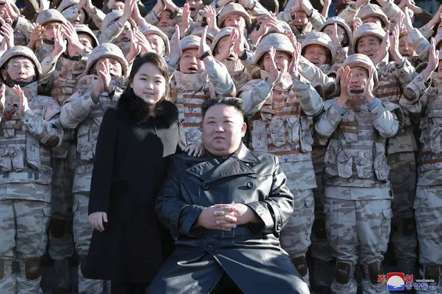 This undated photo provided on November 27, 2022, by the North Korean government shows North Korean leader Kim Jong Un, center right, and his daughter, center left, with soldiers, pose for a photo,  following the launch of what it says a Hwasong-17 intercontinental ballistic missile, at an unidentified location in North Korea. Independent journalists were not given access to cover the event depicted in this image distributed by the North Korean government. The content of this image is as provided and cannot be independently verified. Korean language watermark on image as provided by source reads: “KCNA” which is the abbreviation for Korean Central News Agency. (Photo by Korean Central News Agency/Korea News Service via AP Photo)