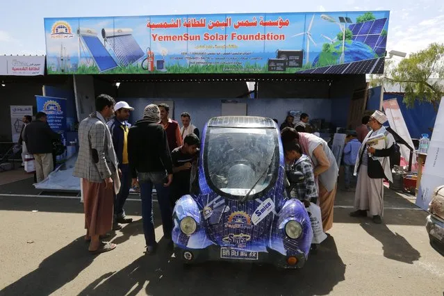 Yemenis gather around a solar powered car as they visit a solar panel fair in Sana'a, Yemen, 23 February 2016. Many Yemenis have turned to the sun as alternative nergy source to power their homes, since the ten-month conflict caused many cities of Yemen, including the capital Sana'a, to completely lose means of generating electricity. (Photo by Yahya Arhab/EPA)