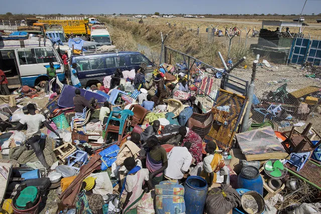 Civilians who fled the recent fighting stack their belongings up outside the gate of the United Nations Mission in South Sudan (UNMISS) compound, hoping to benefit from their protection, after government forces on Friday retook from rebel forces the provincial capital of Bentiu, in Unity State, South Sudan, Sunday, January 12, 2014. (Photo by Mackenzie Knowles-Coursin/AP Photo)