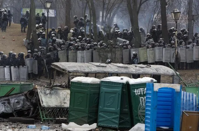 Protesters clash with police in central Kiev, Ukraine,  Monday, Jan. 20, 2014. (Photo by Sergei Chuzavkov/AP Photo)