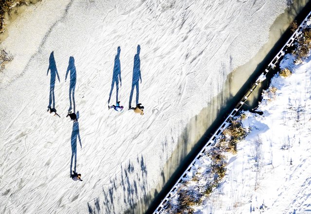 A picture taken with a drone shows skaters on the Broeresloot near Sneek, The Netherlands, 11 February 2021. The Netherlands is eagerly looking forward to the first marathon on natural ice. (Photo by Remko de Waal/EPA/EFE)