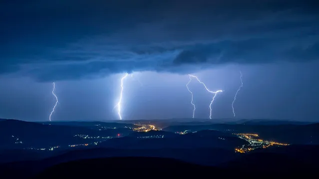 Lightning illuminates the sky over Salgotarjan, Hungary, late Wednesday, July 14, 2021. (Photo by Peter Komka/MTI via AP Photo)