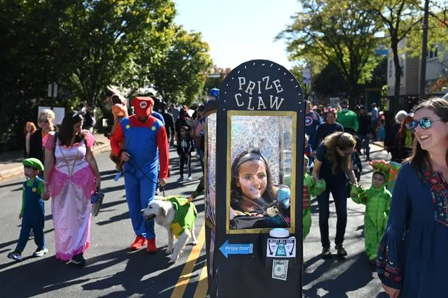Zahra Hersi, center, of Fairfax, VA takes part with her family in the annual Del Ray Halloween Parade on Sunday October 24, 2021 in Alexandria, VA. The parade was cancelled last year. Masks were encouraged since so many unvaccinated children were present. Mask and vaccine mandates are one of many topics that may help decide upcoming political races. The race for Governor of Virginia is a microcosm of the issues that are important to voters nationally. (Photo by Matt McClain/The Washington Post)