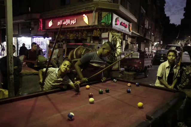 In this October 23, 2018 photo, children play billiards in Shubra, Egypt. (Photo by Nariman El-Mofty/AP Photo)