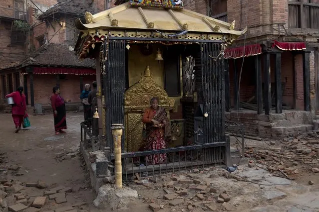 Elderly Nepalese visit a temple in Bhaktapur, Nepal, Saturday, May 2, 2015. A week after the devastating earthquake, life is limping back to normal in Nepal with residents visiting temples on the first Saturday after the quake, a day normally reserved for temple visits. (Photo by Bernat Amangue/AP Photo)