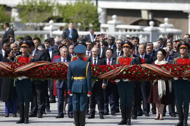 Russian President Vladimir Putin (C), Mongolia's President Tsakhiagiin Elbegdorj (5th R), United Nations Secretary General Ban Ki-moon (3rd R), Kazakhstan's President Nursultan Nazarbayev (4th L) and other officials take part in a wreath laying ceremony on the Victory Day by the Kremlin walls in central Moscow, Russia, May 9, 2015. (Photo by Maxim Shemetov/Reuters)