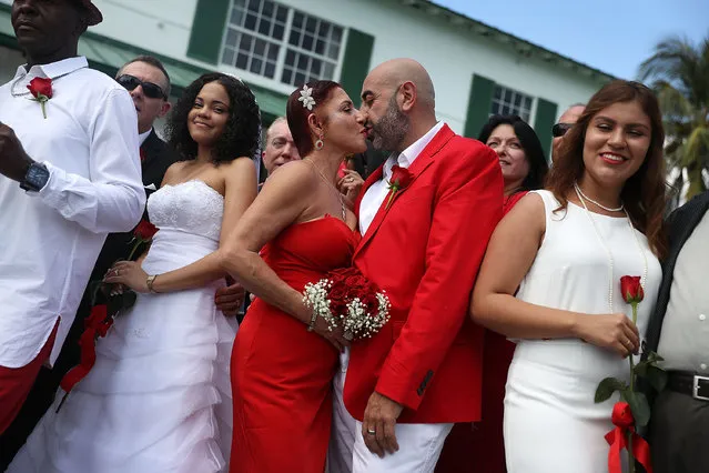 Carmen Lombardo and Armando Merola kiss as they participate in a  group Valentine's day wedding at the National Croquet Center on February 14, 2017 in West Palm Beach, Florida. Approximately 40 couples were married in a ceremony put on by the Palm Beach County Clerk & Comptroller's office. (Photo by Joe Raedle/Getty Images)