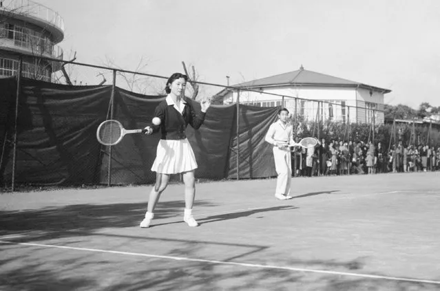 In this December 6, 1958, photo, Michiko Shoda takes the shot as she and her fiance, Crown Prince Akihito, team up for a mixed doubles tennis match at the Tokyo Lawn Tennis club. It was the first time the pair had been photographed together since their engagement was announced November 27. Miss Shoda will become Japan's first commoner queen in more than 2,000 years when Akihito assumes the thrown. When he abdicates April 30, 2019, Akihito will become the first emperor in Japan’s modern history to see his era end without ever having a war. (Photo by AP Photo)