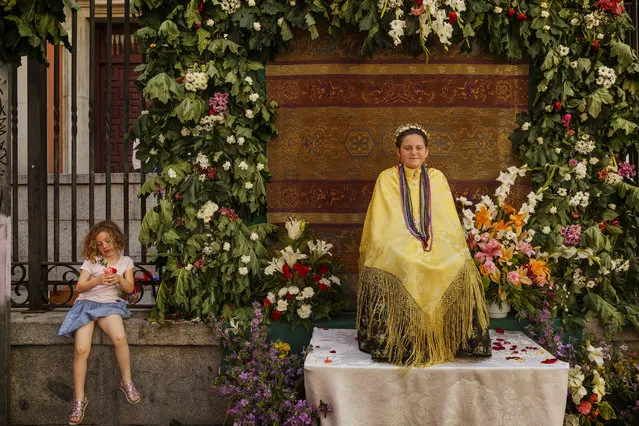 A “Maya” girl sits in an altar during the traditional celebration of “Las Mayas” on the streets in Madrid, Spain Sunday, May 10, 2015. (Photo by Daniel Ochoa de Olza/AP Photo)