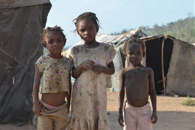 In this March 22, 2015 photo, a group of children pose outside makeshift tents at a borderland encampment outside the southeast Haitian town of Anse-a-Pitres, Haiti. Within a month, authorities hope to move nearly 2,400 people in a half-dozen encampments by providing enough money for them to rent homes for a year in nearby towns. (Photo by David McFadden/AP Photo)