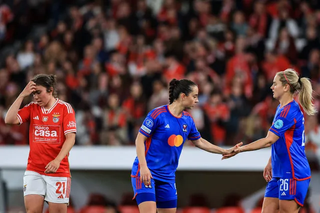 Lyon's German midfielder #8 Sara Dabritz (C) celebrates victory with Lyon's US midfielder #26 Lindsey Horan (R) at the end of the UEFA Women's Champions League quarter final first leg football match between SL Benfica and Olympique de Lyon at the Luz stadium in Lisbon on March 19, 2024. Lyon won 1-2. (Photo by Patrícia de Melo Moreira/AFP Photo)