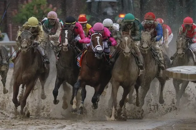 Luis Saez riding Maximum Security, second from right, goes around turn four with Flavien Prat riding Country House, left, Tyler Gaffalione riding War of Will and John Velazquez riding Code of Honor, right, during the 145th running of the Kentucky Derby horse race at Churchill Downs Saturday, May 4, 2019, in Louisville, Ky. (Photo by John Minchillo/AP Photo)