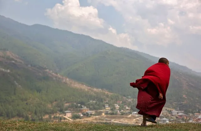A young monks takes a break from his studies at Changangkha Lhakhang temple in Thimphu, Bhutan, April 13, 2016. (Photo by Cathal McNaughton/Reuters)