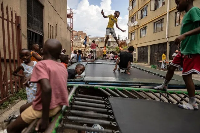 Children jump on trampolines in Alexandra, a South African township near Johannesburg, on Saturday, March 9, 2024. (Photo by Olympia de Maismont/AFP Photo)