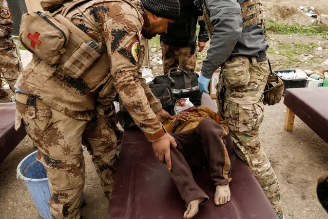 A boy injured in a mortar attack is treated by medics in a field clinic as Iraqi forces battle with Islamic State militants, in western Mosul, Iraq March 2, 2017. (Photo by Zohra Bensemra/Reuters)