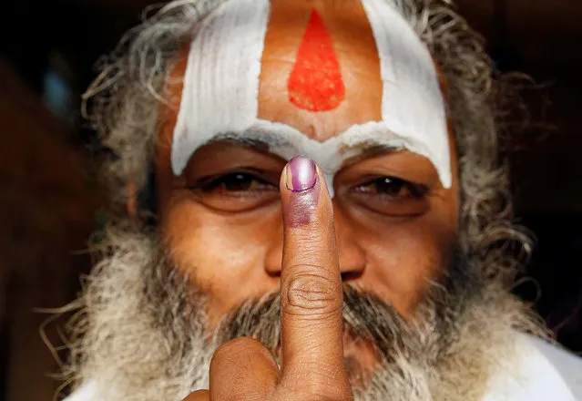 A Sadhu, or Hindu holy man shows his ink marked finger after voting during the state assembly election, in the town of Ayodhya, in the state of Uttar Pradesh, India, February 27, 2017. (Photo by Cathal McNaughton/Reuters)