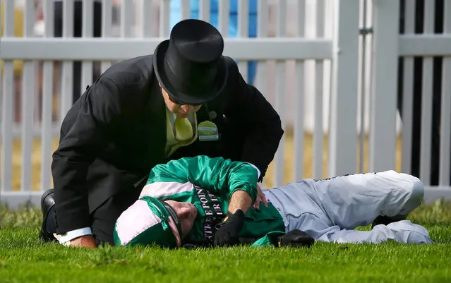 Horse Racing - Royal Ascot - Ascot Racecourse - 17/6/15
Jimmy Fortune lies injured after falling off Spark Plug during the 17.00 Royal Hunt Cup
Reuters / Eddie Keogh
Livepic
