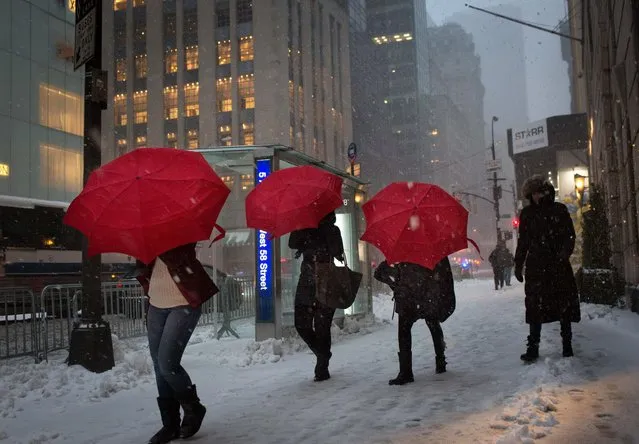 Tourists walk up Fifth Avenue during a day of heavy snow and freezing rain on March 14, 2017 in New York City. Much of the Northeast is under a state of emergency as a blizzard is expected to bring over one foot of snow and high winds to the area. (Photo by Kevin Hagen/Getty Images)