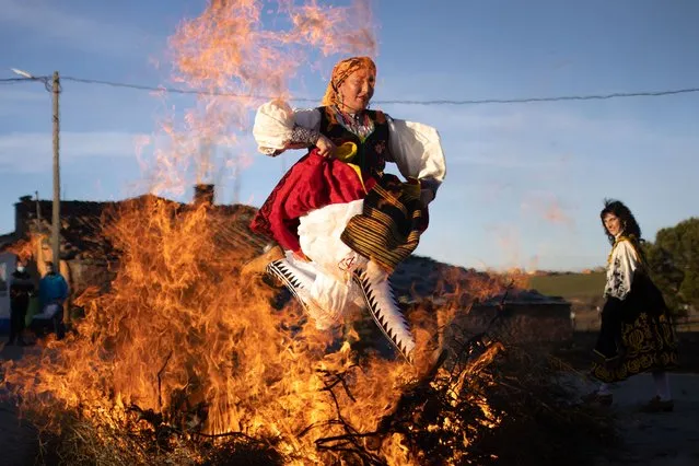 A woman dressed in traditional costumes jumps over a bonfire to commemorate the day of Santa Agueda in Andavias, Spain, on February 6, 2022. In the province of Zamora it is quite a tradition, the women take over the city and the towns to gain control in the province, the councils give them the batons as a sign of authority, they celebrate around 7 days of festivity where they dance, eat, live the festival and honor Santa Agueda. (Photo by Manuel Balles/ZUMA Press Wire/Rex Features/Shutterstock)