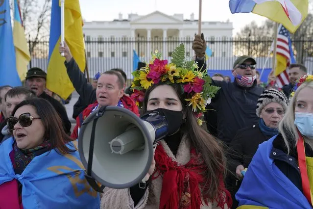 People gather following a vigil and march in solidarity with Ukraine outside the White House in Washington, Sunday, February 20, 2022. (Photo by Patrick Semansky/AP Photo)