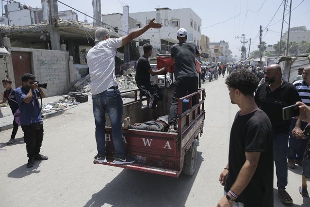 Palestinians evacuate dead and wounded in the Israeli bombardment of the Gaza Strip in Deir al Balah on Saturday, June 8, 2024. (Photo by Jehad Alshrafi/AP Photo)