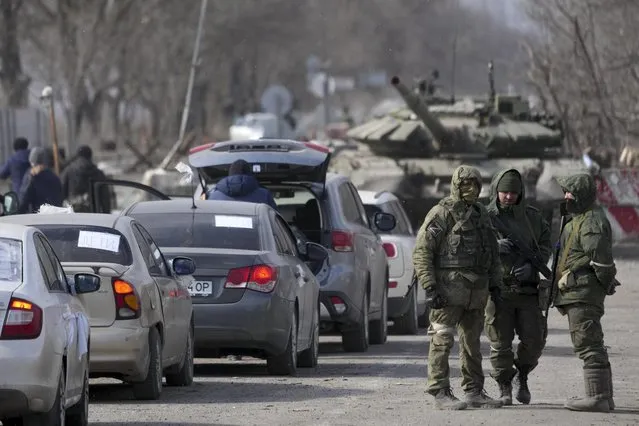 Civilians trapped in Mariupol city under Russian attacks, are evacuated in groups under the control of pro-Russian separatists, through other cities, in Mariupol, Ukraine on March 20, 2022. (Photo by Stringer/Anadolu Agency via Getty Images)