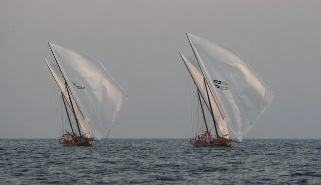 Traditional wooden boats, or dhows, sail during practice in the evening near Sir Bu Nuayr Island ahead of the Al Gaffal race, a long-distance dhow sailing race, near Sharjah May 17, 2014. (Photo by Martin Dokoupil/Reuters)