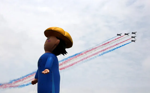 Military planes fly past a parade during an inauguration ceremony of Taiwan’s President Tsai Ing-wen in Taipei, Taiwan May 20, 2016. (Photo by Tyrone Siu/Reuters)