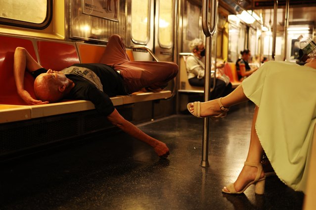 A man sleeps in a subway train in New York city on August 1, 2024. (Photo by Charly Triballeau/AFP Photo)