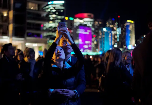 A couple embrace as they experience the opening night of the annual Vivid Sydney light festival in Sydney, Australia May 27, 2016. (Photo by Jason Reed/Reuters)