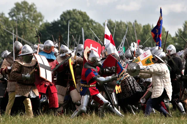 People fight during a reenactment of the Battle of Agincourt, in Agincourt, northern France, Saturday, July 25, 2015. (Photo by Thibault Camus/AP Photo)