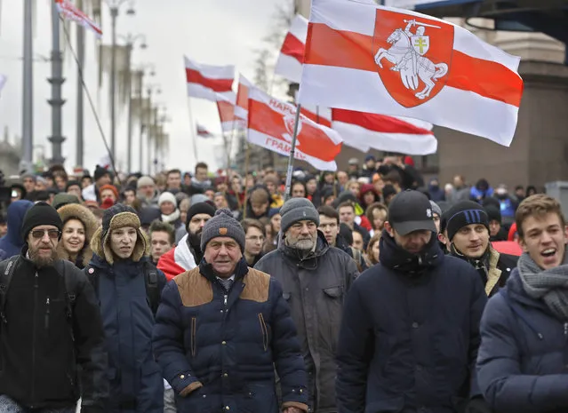 Protesters attend a procession in downtown Minsk, Belarus, Sunday, December 8, 2019. A rally was held to protest closer integration with Russia which protesters fear could erode the post-Soviet independence of Belarus, a nation of 10 million. (Photo by Sergei Grits/AP Photo)