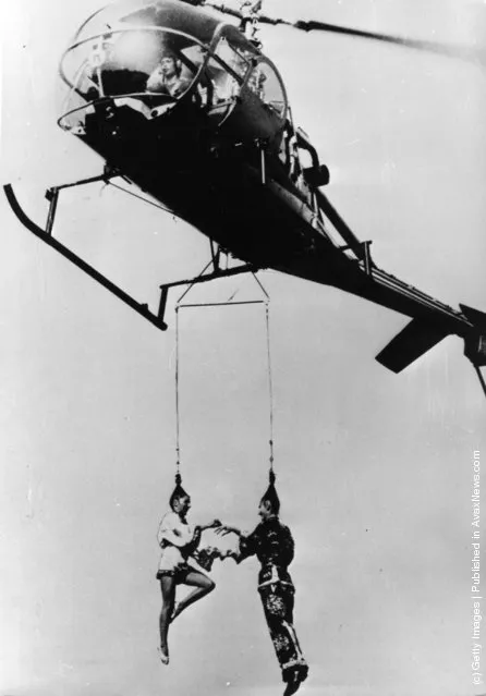Tsen Hai Sun and Hay Gy Sun, hanging by their hair beneath a hovering Bell helicopter, exchange gold rings in an unusual wedding ceremony in Hassloch, Pfalz, West Germany, 1979