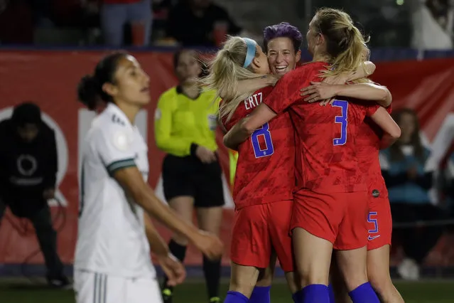 U.S. players, including Megan Rapinoe, facing camera, and Julie Ertz, left, celebrate after a goal by midfielder Samantha Mewis (3) during the first half of a CONCACAF women's Olympic qualifying soccer match against Mexico on Friday, February 7, 2020, in Carson, Calif. (Photo by Chris Carlson/AP Photo)