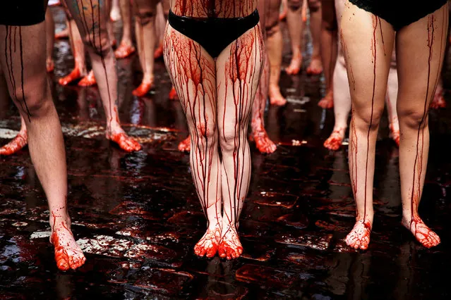 Animal rights protesters covered in fake blood demonstrate for the abolition of bull runs and bullfights a day before the start of the famous running of the bulls San Fermin festival in Pamplona, northern Spain, July 5, 2016. (Photo by Susana Vera/Reuters)