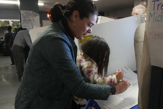 Vesta Avery, 2, helps her mother Alexis Taylor mark her ballot at P.S. M811, The Mickey Mantle School, in New York, Tuesday, November 5, 2024. (Photo by Richard Drew/AP Photo)