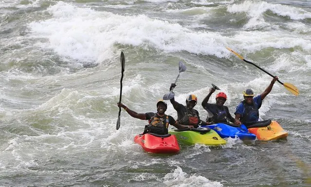 Yusuf Basalirwa, 23, David Moore, 23, Sadat Kawawa, 23, and David Egesa, 40, members of Uganda's kayaking team pose for a picture during a team practice session in the River Nile in Jinja, east of Uganda's capital Kampala, August 19, 2015, in preparation for the ICF Freestyle world championships later this month in Ottawa, Canada. (Photo by James Akena/Reuters)