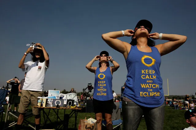 People watch the solar eclipse during the Lowell Observatory Solar Eclipse Experience at Madras High School in Madras, Oregon on August 21, 2017. (Photo by Jason Redmond/Reuters)