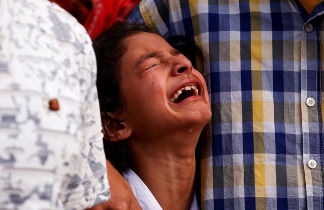 A girl mourns as policemen carry the body of Abdul Rasheed, a police officer, who according to the Indian police was shot by suspected militants in Anantnag, during his wreath laying ceremony in Srinagar, August 28, 2017. (Photo by Danish Ismail/Reuters)