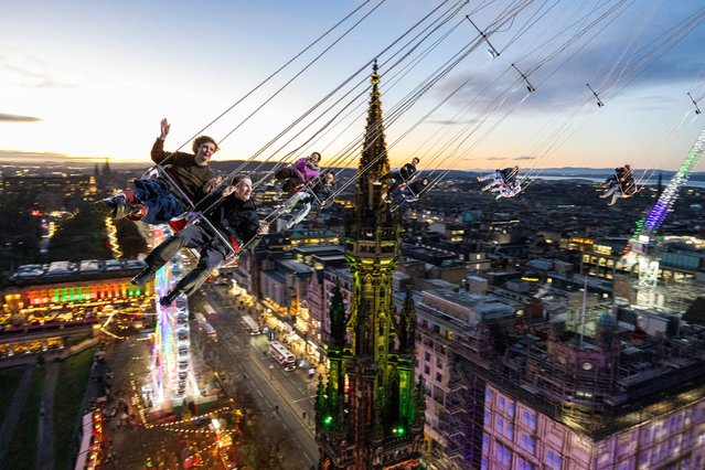 Keira Marlow and Archie Vick enjoy the 80m-high Star Flyer at the Edinburgh Christmas Market in Princes Street Gardens on November 28, 2024. (Photo by Duncan McGlynn/The Times)