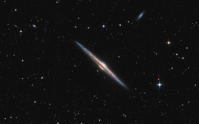 “Galaxies”. Highly Commended: NGC 4565 – Needle Galaxy by Andriy Borovkov (Ukraine) NGC 4565 in the constellation of Coma Berenices, approximately 40 million light years away, is known as the Needle Galaxy and is more luminous than our neighbouring galaxy, Andromeda. As we look at this galaxy from the side on Earth, the spiral arms are in a ray. Elmshorn, Pinneberg, Schleswig-Holstein, Germany, 14 March 2016 UNC 30512 300 mm f/4 reflector telescope, Sky-Watcher EQ8 mount, Moravian Instruments G2-8300 mono camera, 9.-hour total exposure. (Photo by Andriy Borovkov/Insight Astronomy Photographer of the Year 2017)